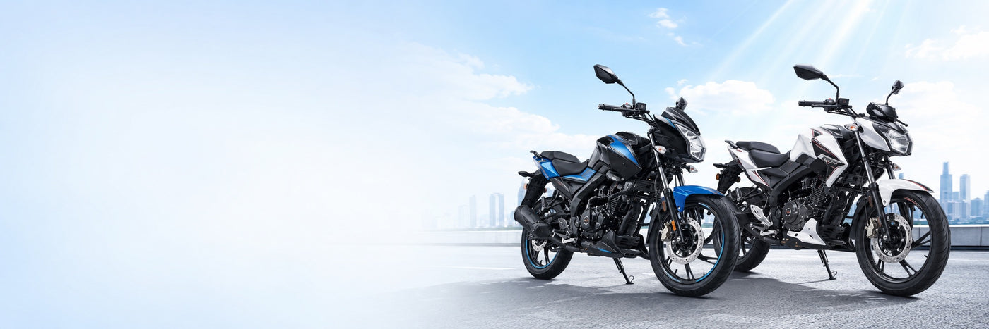Bajaj Pulsar motorcycles parked on a city highway